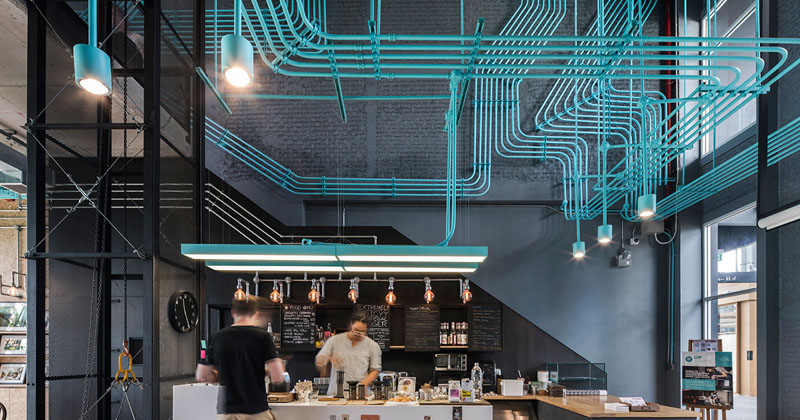 Turquoise electrical conduit is a design feature running through this