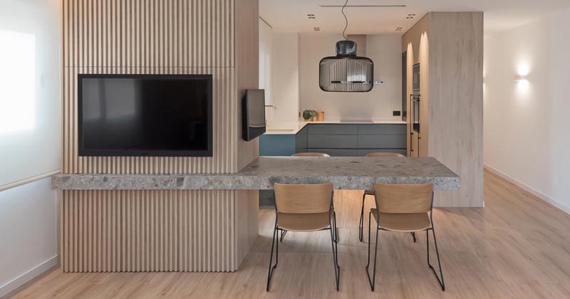 A Cantilevered Dining Table Separates The Kitchen And Living Room In This Apartment