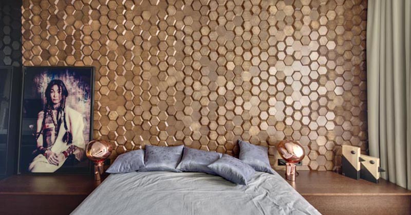 A Bedroom Accent Wall Made From 3D Hexagonal Wood Tiles