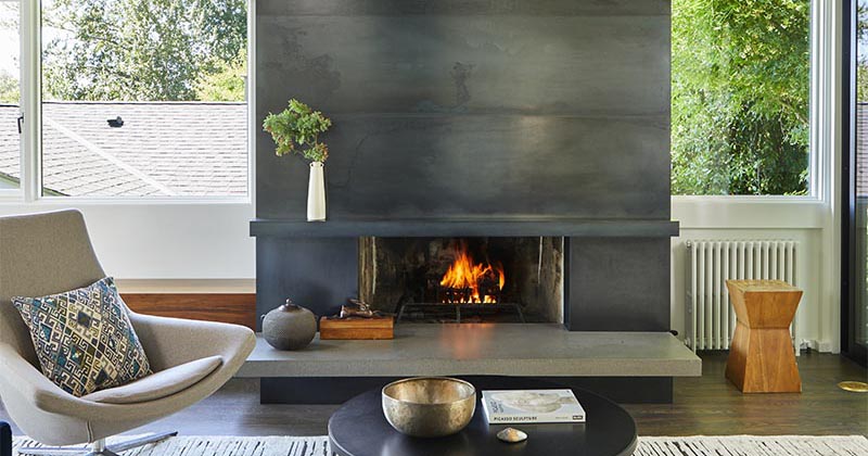 A Blackened Steel Fireplace Surround With A Concrete Hearth Is A Strong Look Inside This Mid-Century Modern House
