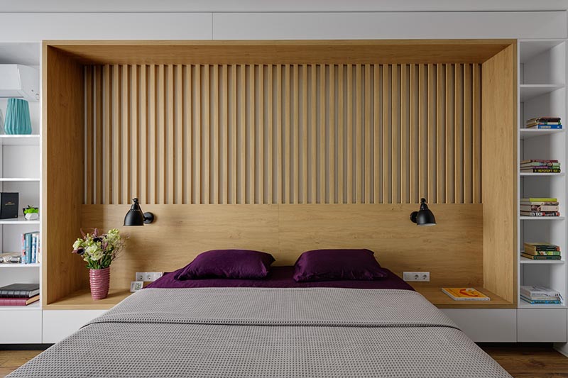 A Wall In This Bedroom Was Fully Built-In With Shelving, Headboard