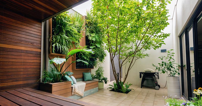 Wall Planters Provide A Low Maintenance Garden For This Small Courtyard