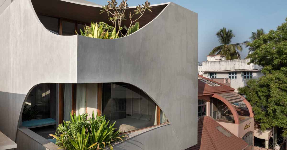 A Curvy Concrete Cube With Cut Outs For Windows Is The Form Of This New Home