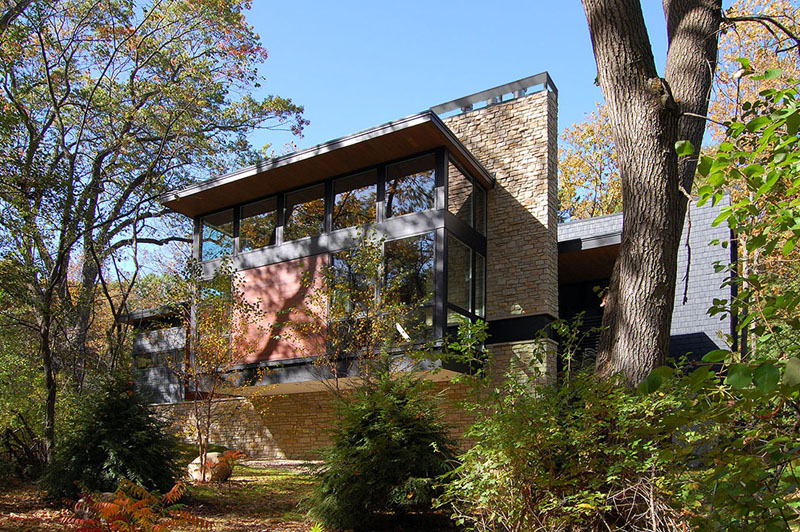 A new contemporary house in Wisconsin is covered in stone and shingles