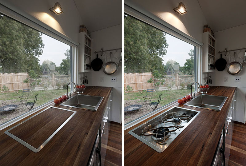 In tiny tiny home, the kitchen has a cover to hide the cooktop and provide additional prep space for when you're getting ready to cook.