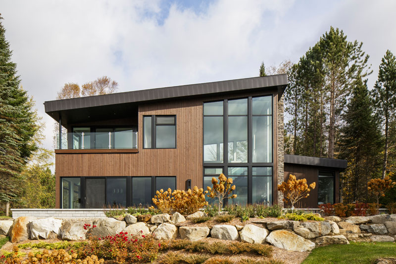 This modern lake house in Canada has an exterior clad in wood, stone ...