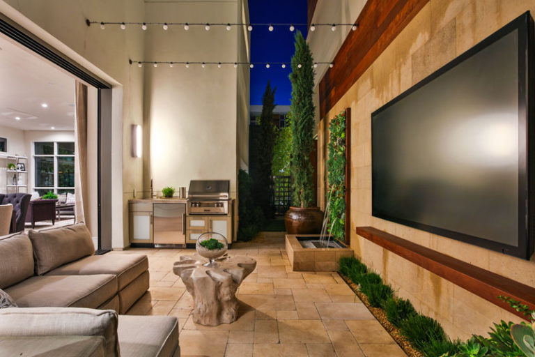 This Small Patio Includes An Outdoor Kitchen And Entertainment Space