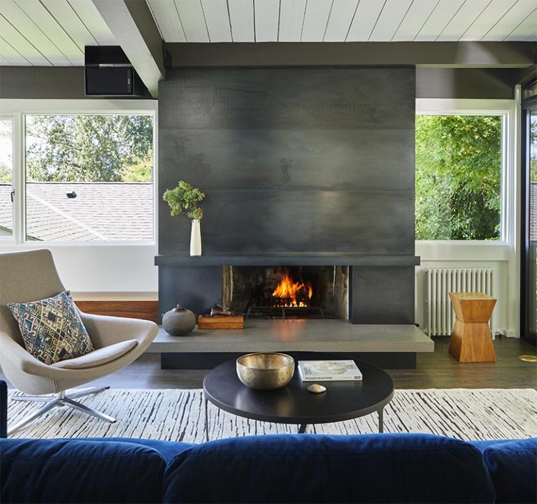 A Blackened Steel Fireplace Surround With A Concrete Hearth Is A Strong ...