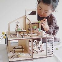 A Modern Wood Dollhouse Kit With Matching Furniture