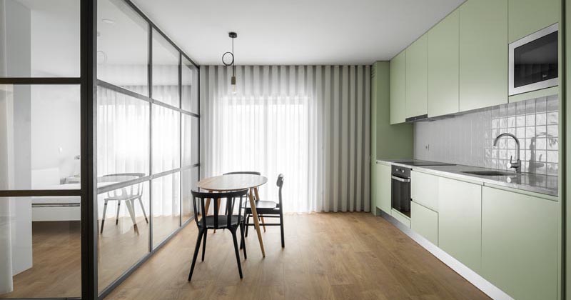 A Glass Enclosed Bedroom Allows Light To Travel Freely In This Small Apartment