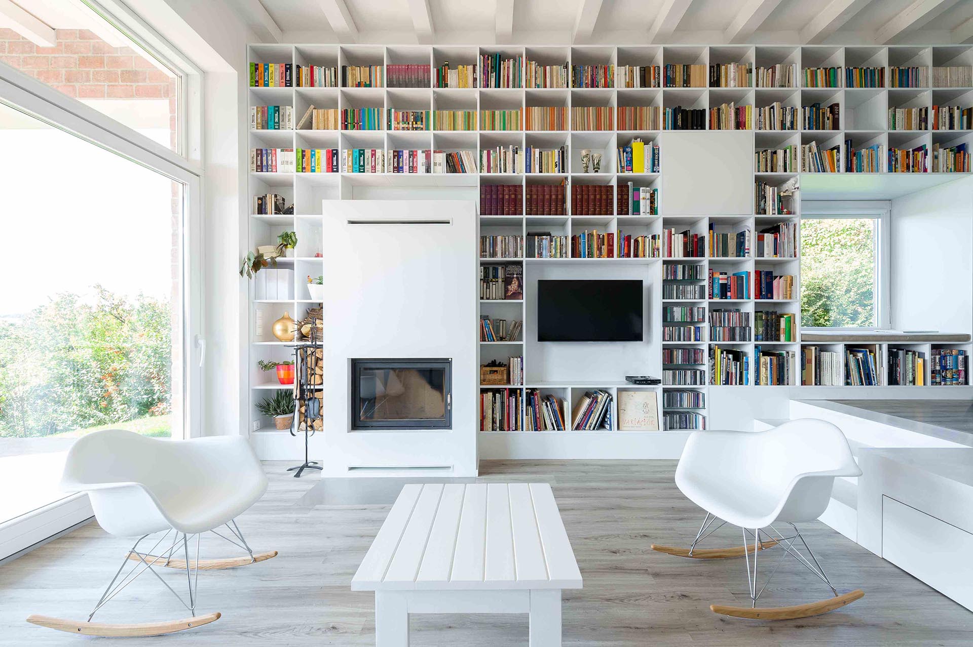 This Long Wall Of Shelving Incorporates Storage, A Fireplace