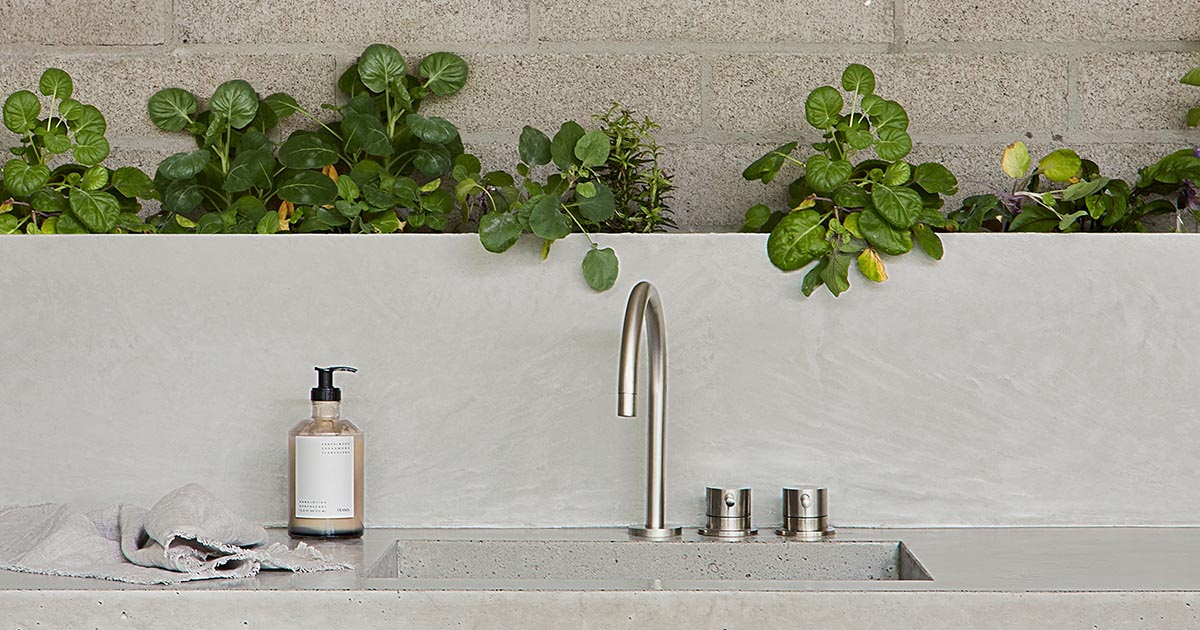 A Row Of Plants Along The Backsplash Adds A Green Touch To This Kitchen