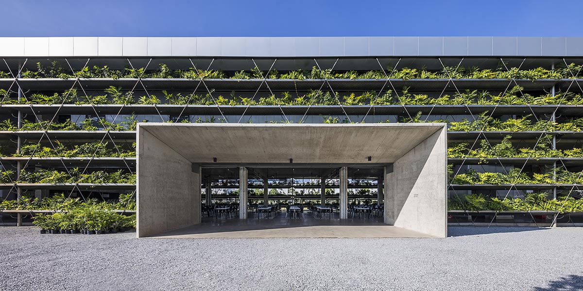 Rows Of Plants Line The Exterior Of This Factory Building