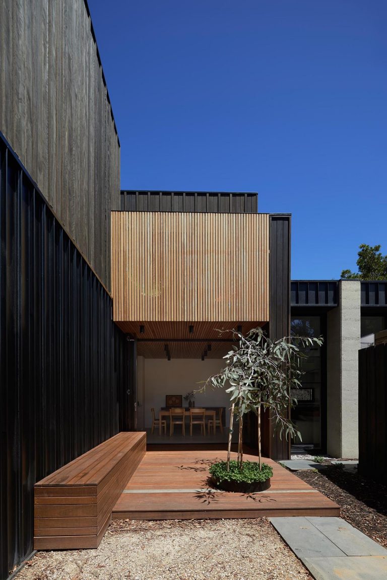 An Exterior Of Blackbutt Timber Hides The Bright White Interior Of This