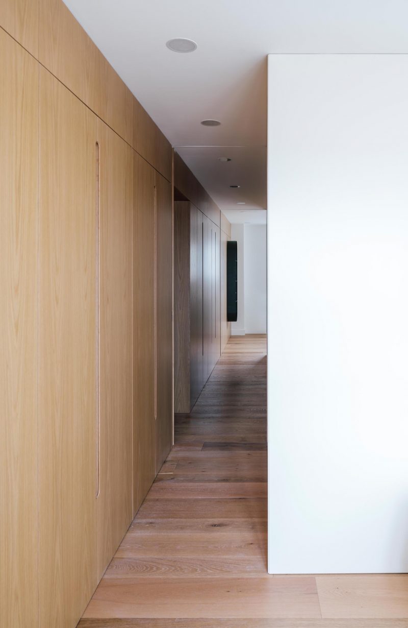 A wood wall with built-in closets.