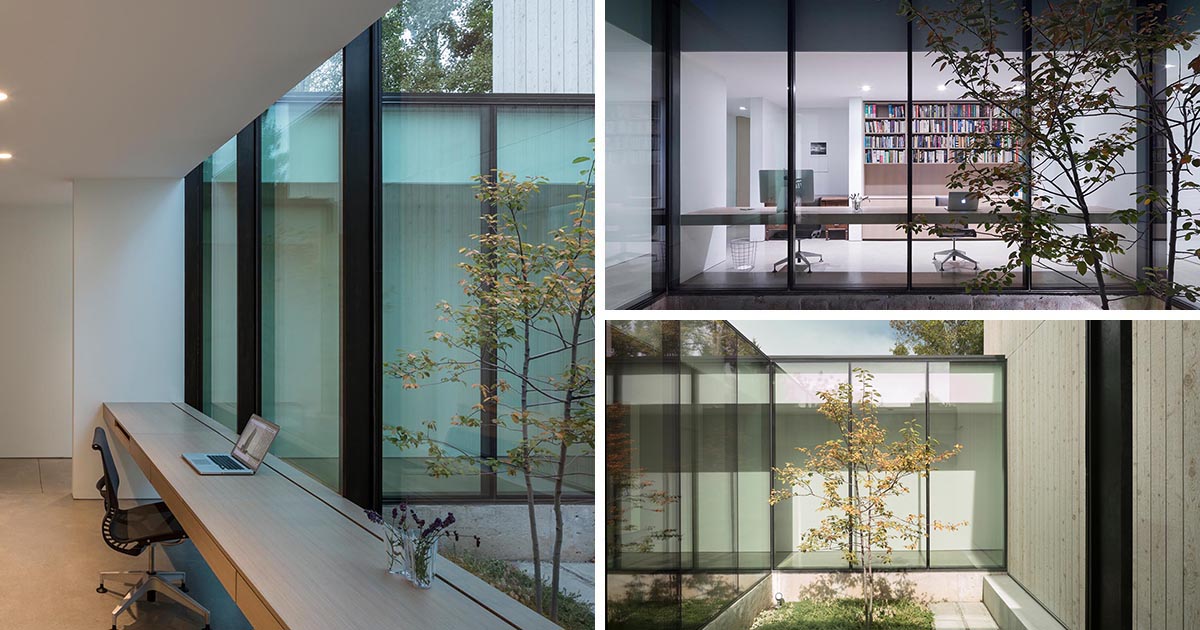 A Home Office Was Made Possible By Building A Desk Along A Wall Of Windows Inside This House