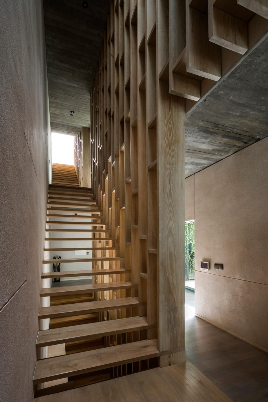 Extensive Hanging Plants Soften The Use Of Concrete In This Homes Design