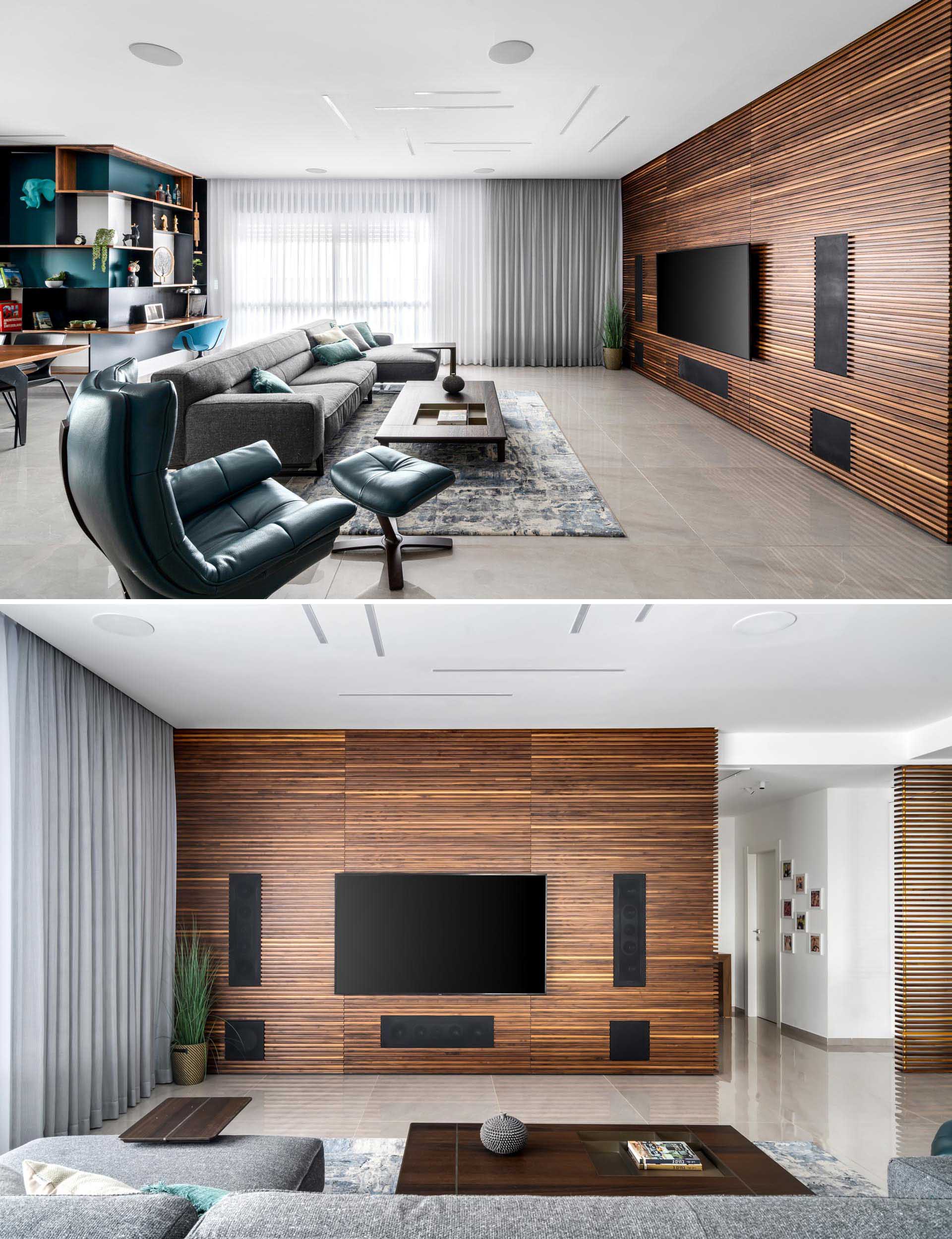 In this modern living room, a wood slat accent wall made from walnut becomes the backdrop for the television