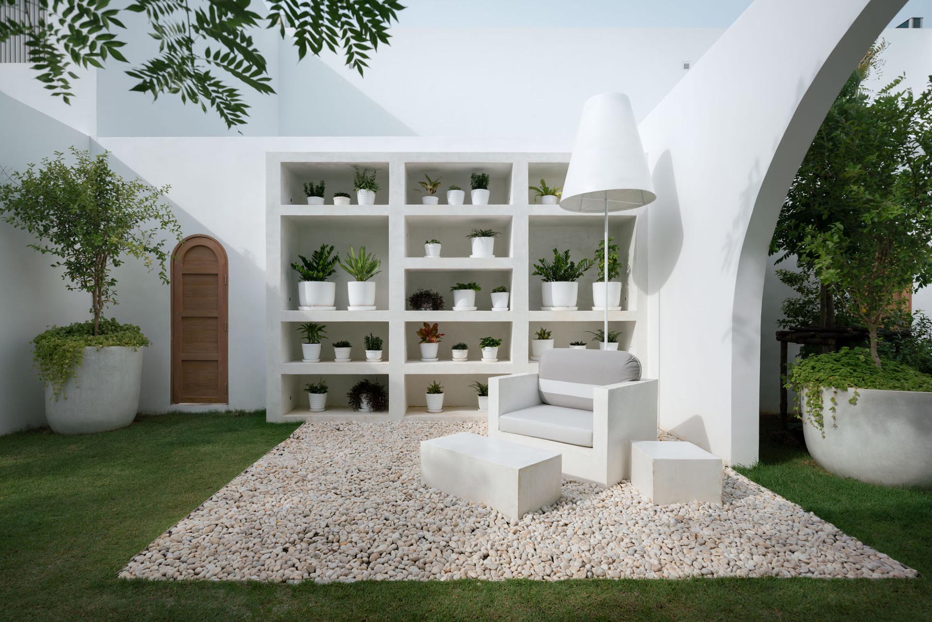 An outdoor living room with a shelving unit designed to house plants.