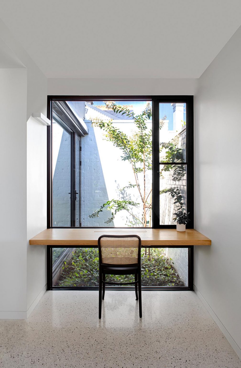 A Plank Of Wood In Front Of A Window Is An Easy Way To Make A Desk For ...