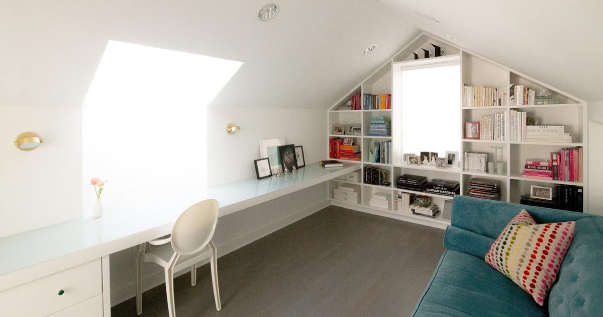 A Symmetrical Bookshelf Designed To Fill The Wall Around A Window Completes One End Of This Home Office