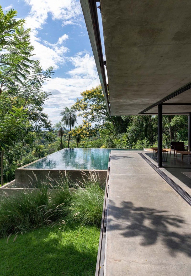 The Green Roof On This Home Has Tall Grasses Surrounding A Seating Area