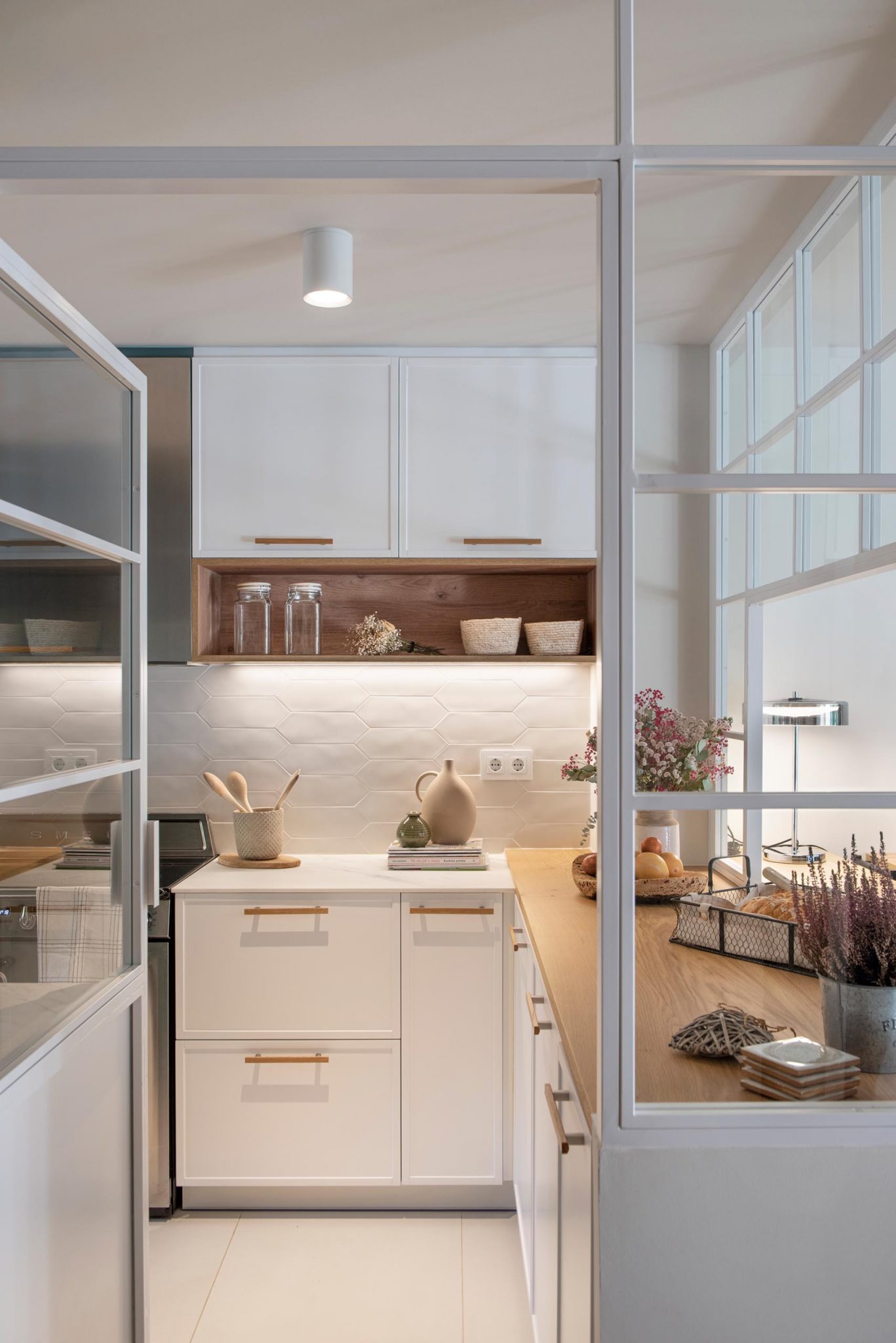 A Glass Enclosed Kitchen Is A Noticeable Design Feature Of This Home