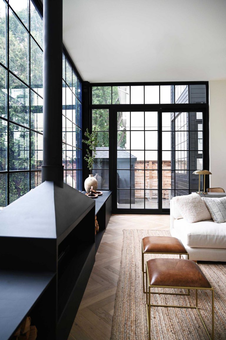 A Grid Of Square Black Window Frames Cover The Back Wall Of This ...