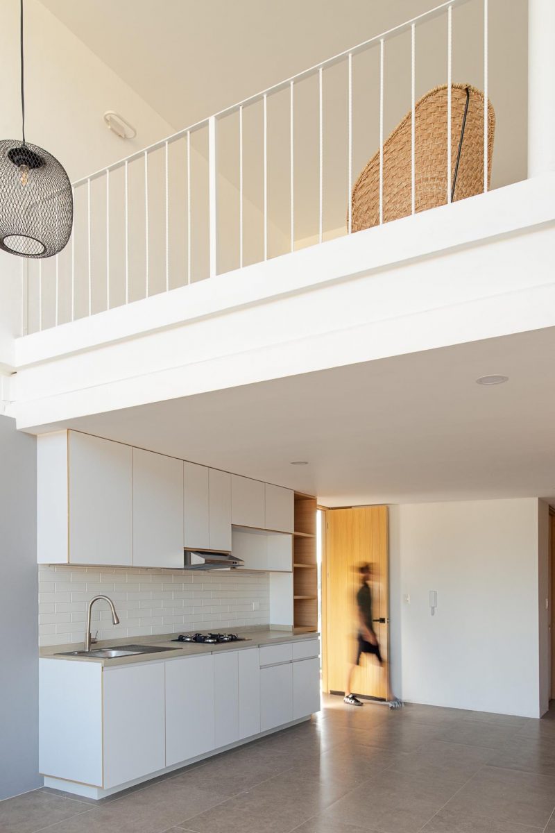 An Under-Stair Seating Nook Lined With Wood Creates A Cozy Place For