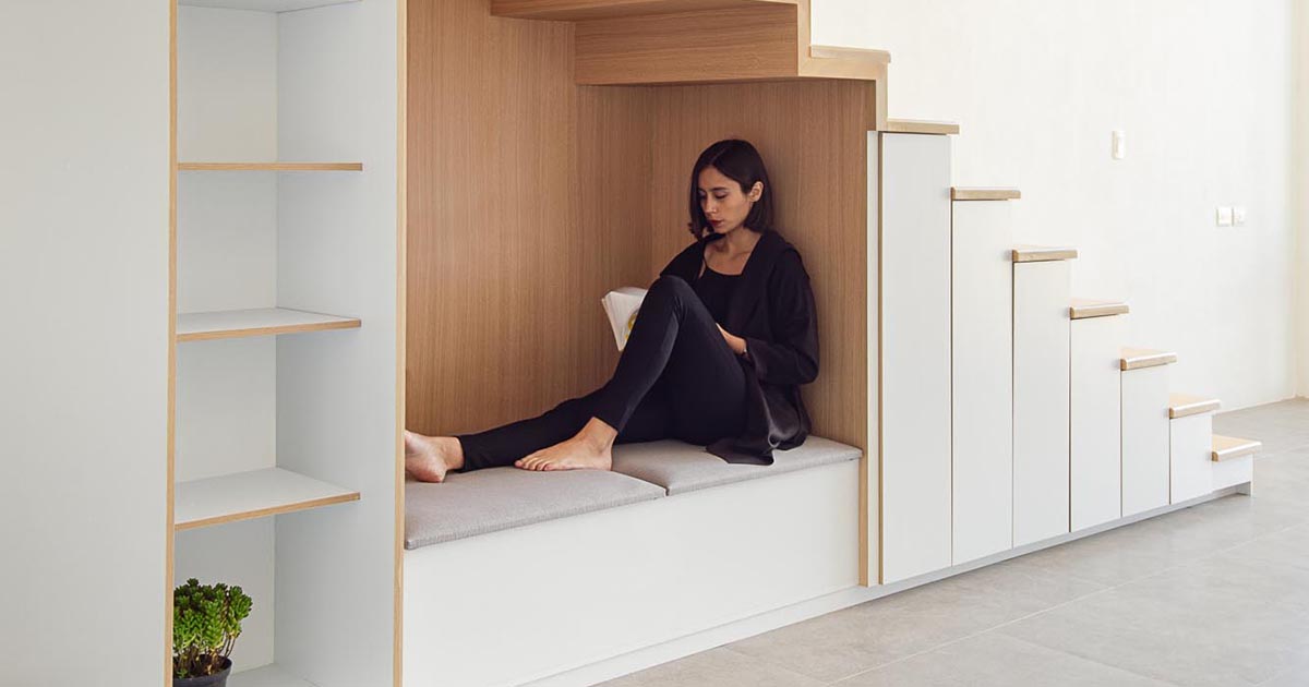 An Under-Stair Seating Nook Lined With Wood Creates A Cozy Place For Reading And Relaxation