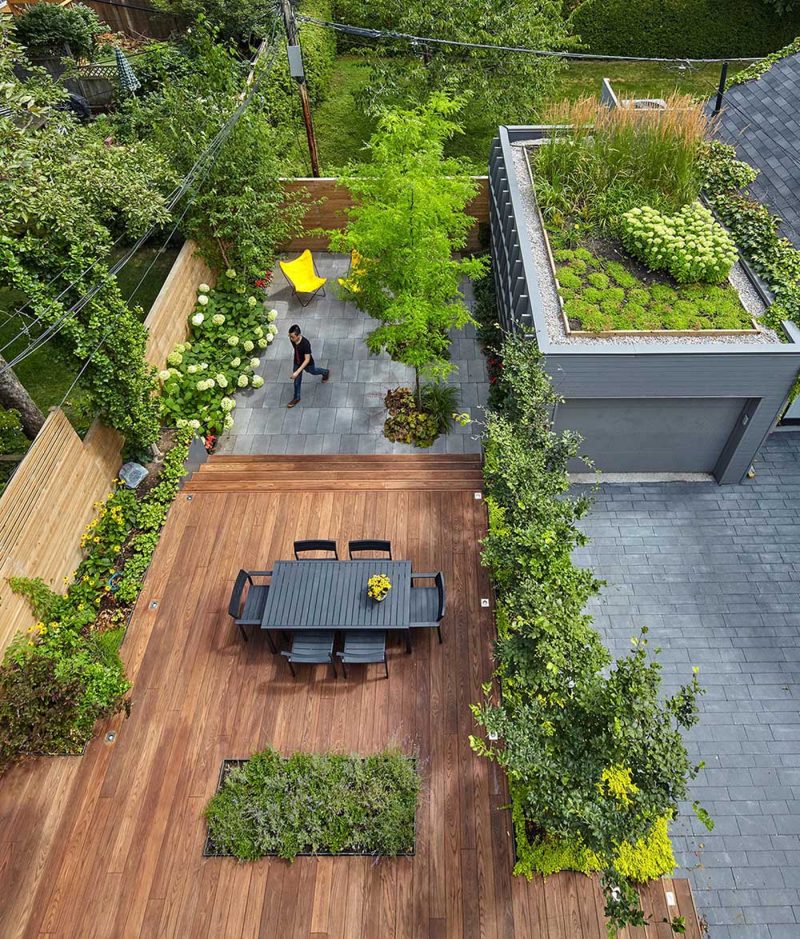 Large Windows Overlook A Garage With A Green Roof At This Home In Toronto