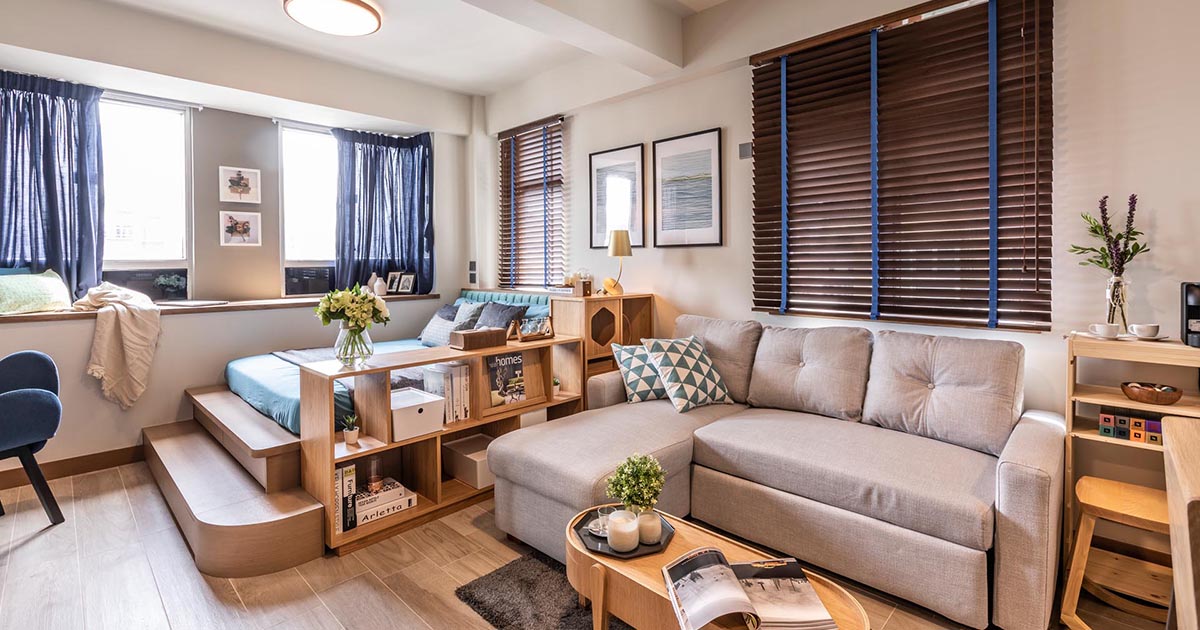 Shelving And A Built-In Platform Help To Separate The Bed From The Rest Of This Small Apartment