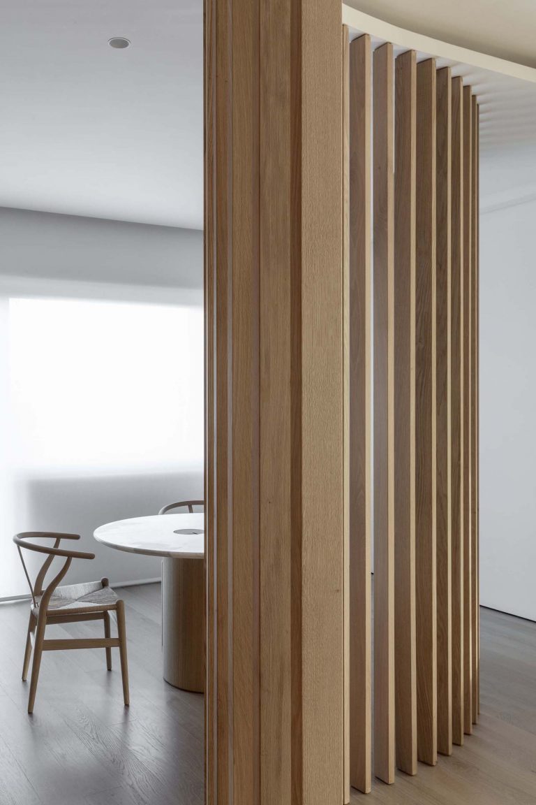 Oak Slat Walls Divide The Spaces Inside This Apartment's Interior