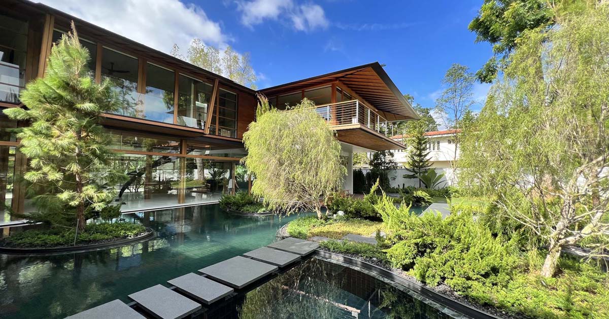 Bridges Connect To An Island In The Water-Filled Courtyard Of This Home In Singapore