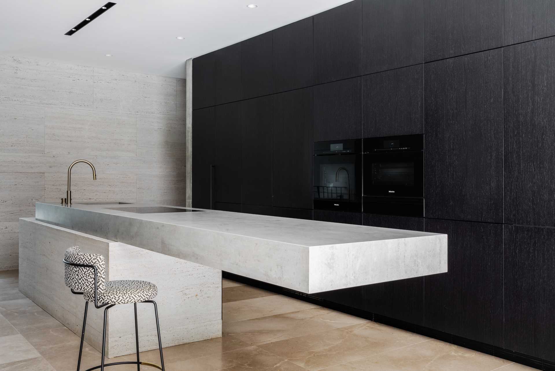 A minimalist kitchen with a cantilevered island.
