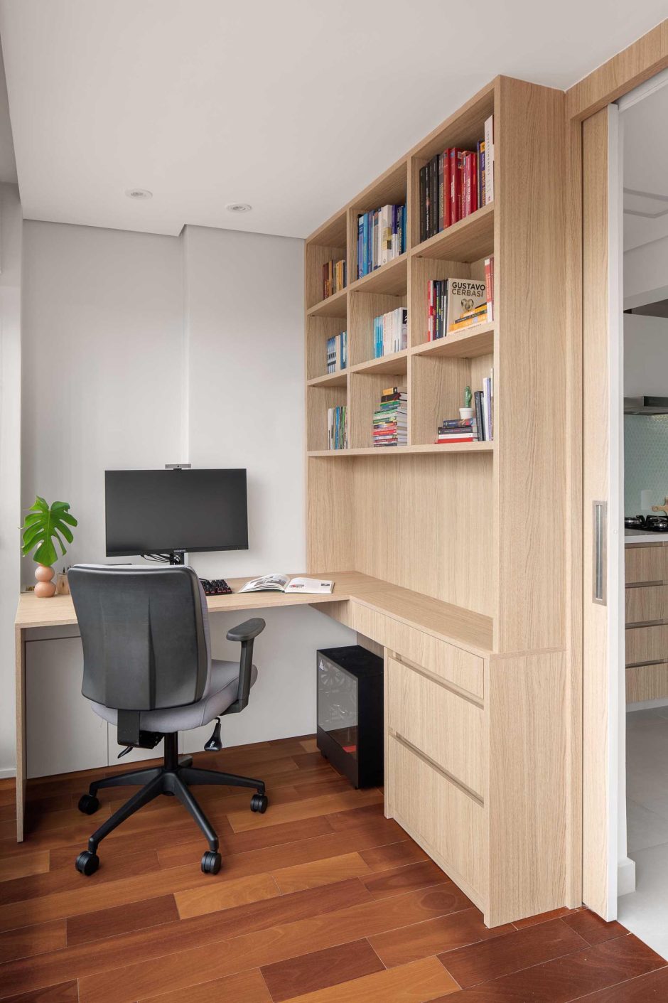 A Home Office And Kitchen Are Hidden Behind A Sliding Wall In This ...