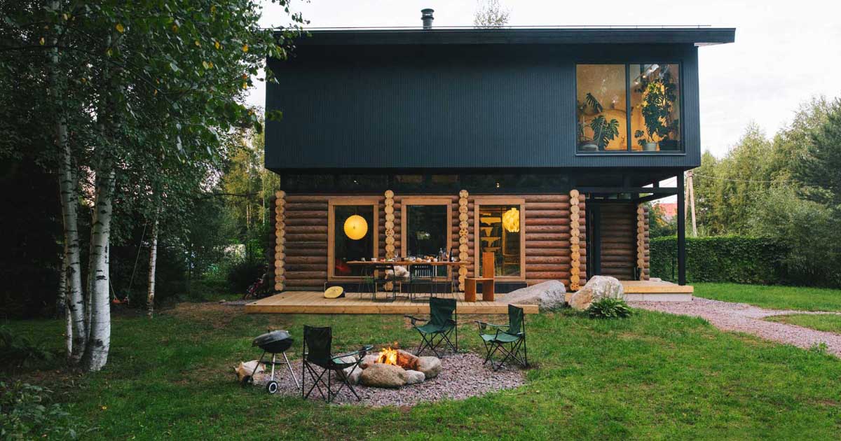 A Pile Of Logs From An Old House Were Used To Create The Bottom Half Of This New Home