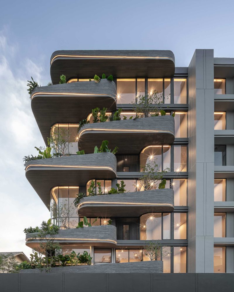 Lighting Is Used To Highlight The Rounded Balconies Of This Building