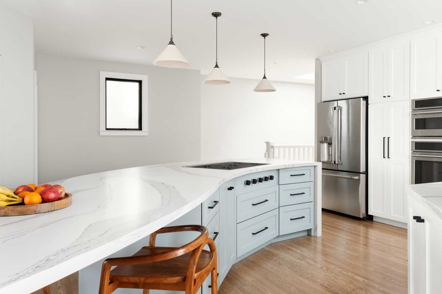 An S Shaped Kitchen Island Flows Through This Remodeled Home   Modern White Kitchen With Curved Island 300123 1149 03 1536x1024 