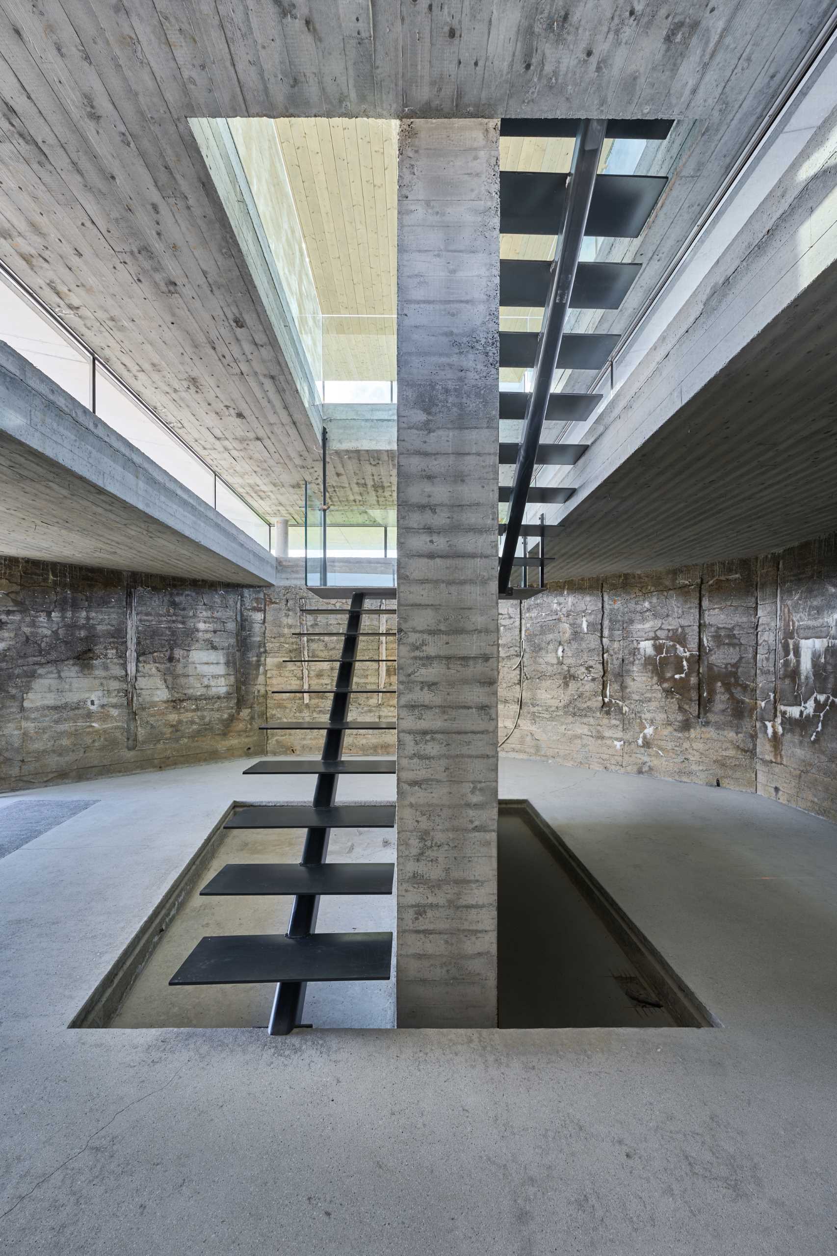The stairs are put in as a central and sculptural element, leading from the closed parts of the bunker and up to the light of the event space.