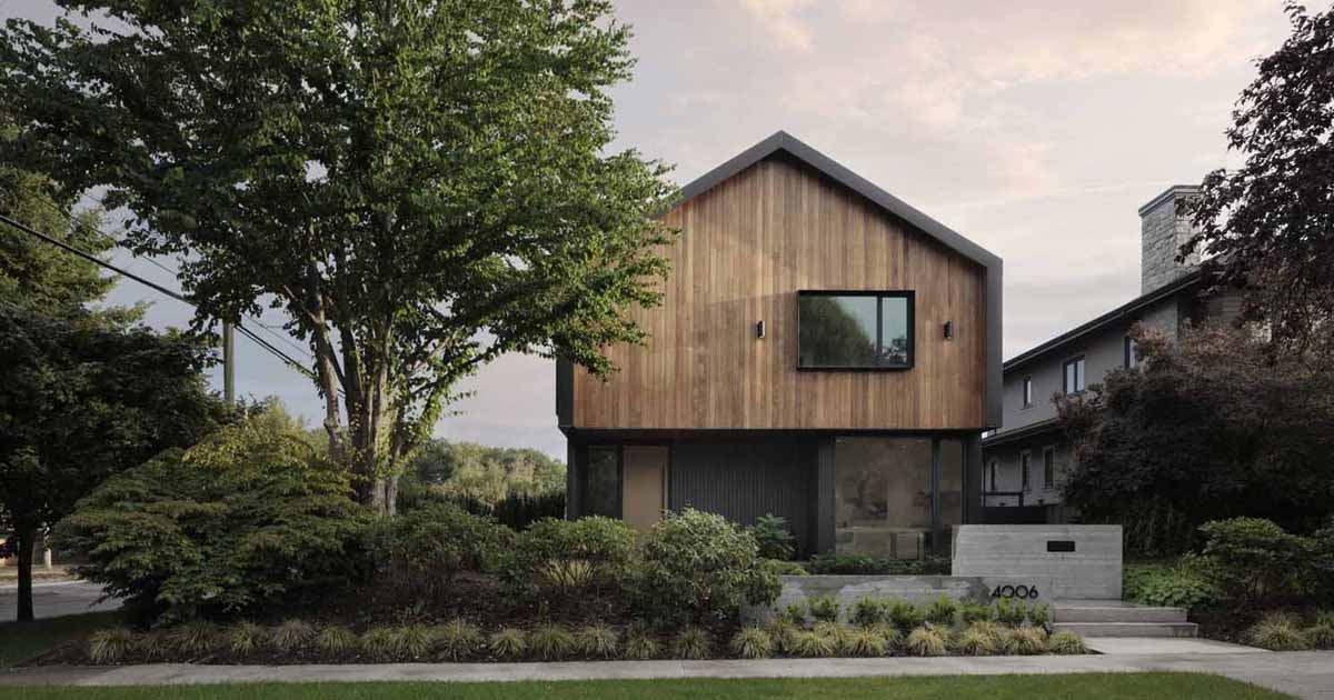 Metal Cladding Wraps Around The Large Gable Roof Of This House
