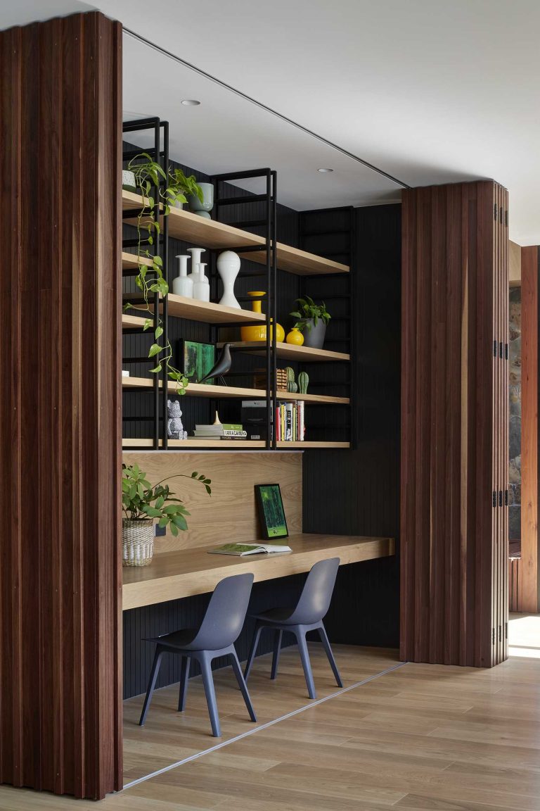 A Home Office Was Hidden Behind A Wall That Folds Open