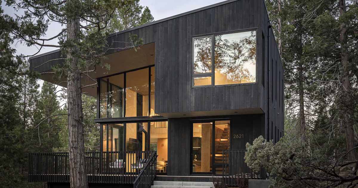 Dark Vertical Wood Siding Was Chosen As The Primary Exterior Cladding To “Camouflage” This Cabin
