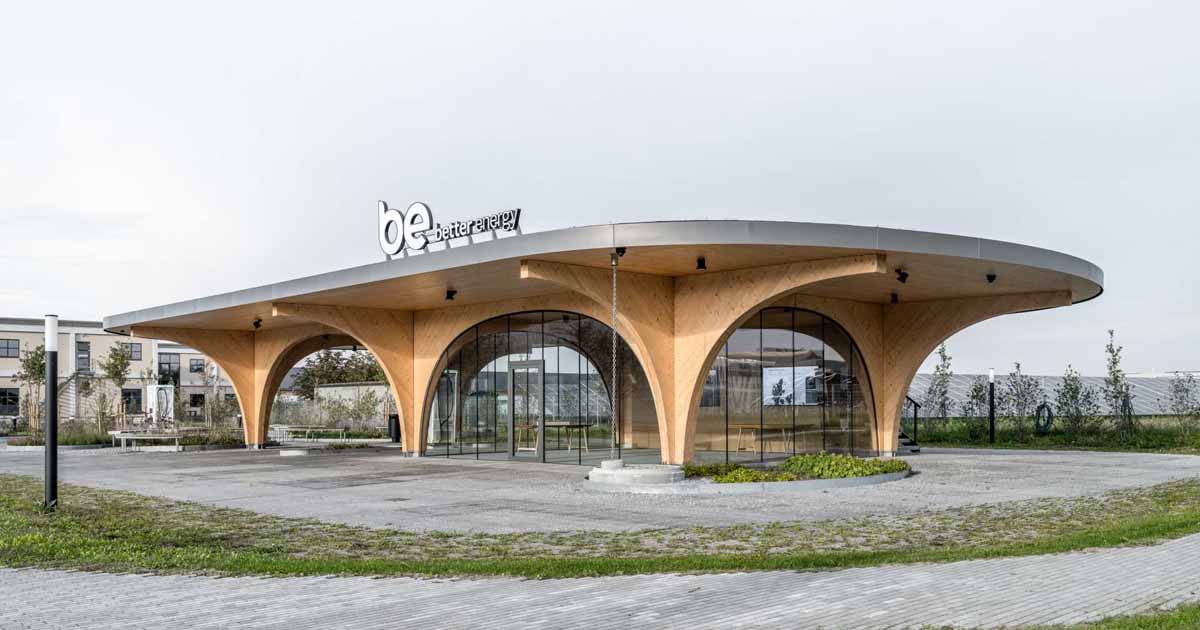 Large Wood Arches Dramatically Elevate The Roof Of This Charging Station