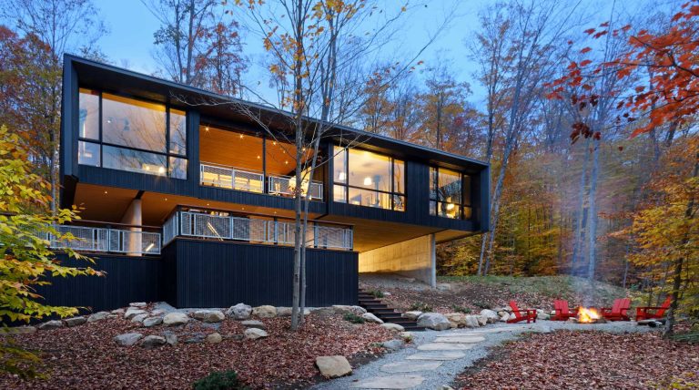 This Lakehouse Hovers Above The Natural Sloped Terrain