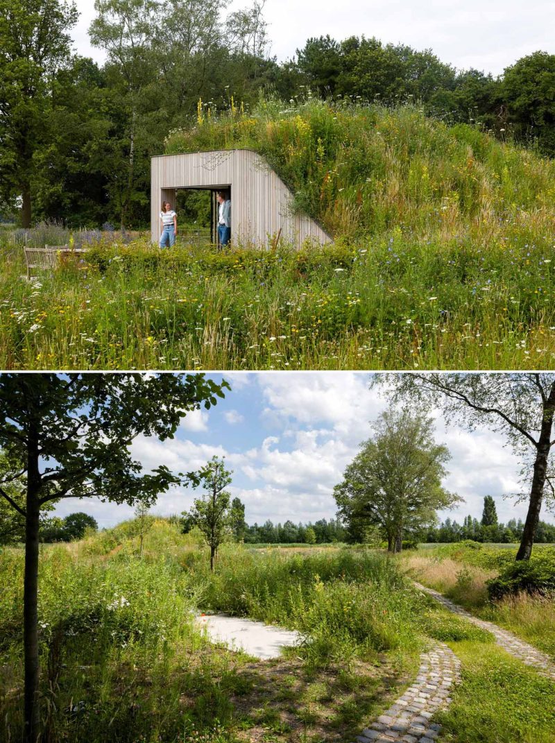 A House Built Into The Ground And Covered In Flowers