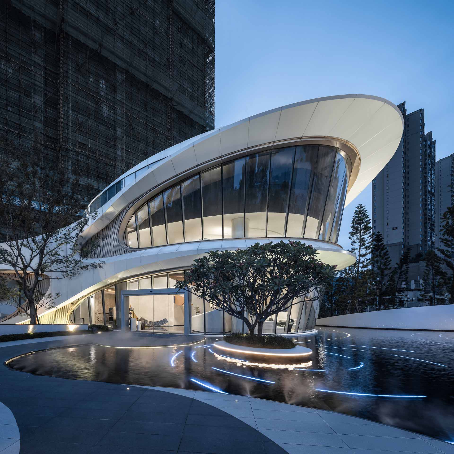 A community center whose exterior features silver-white aluminum plate and champagne gold perforated aluminum plate to simulate the flexible curve lines of the butterfly wings.