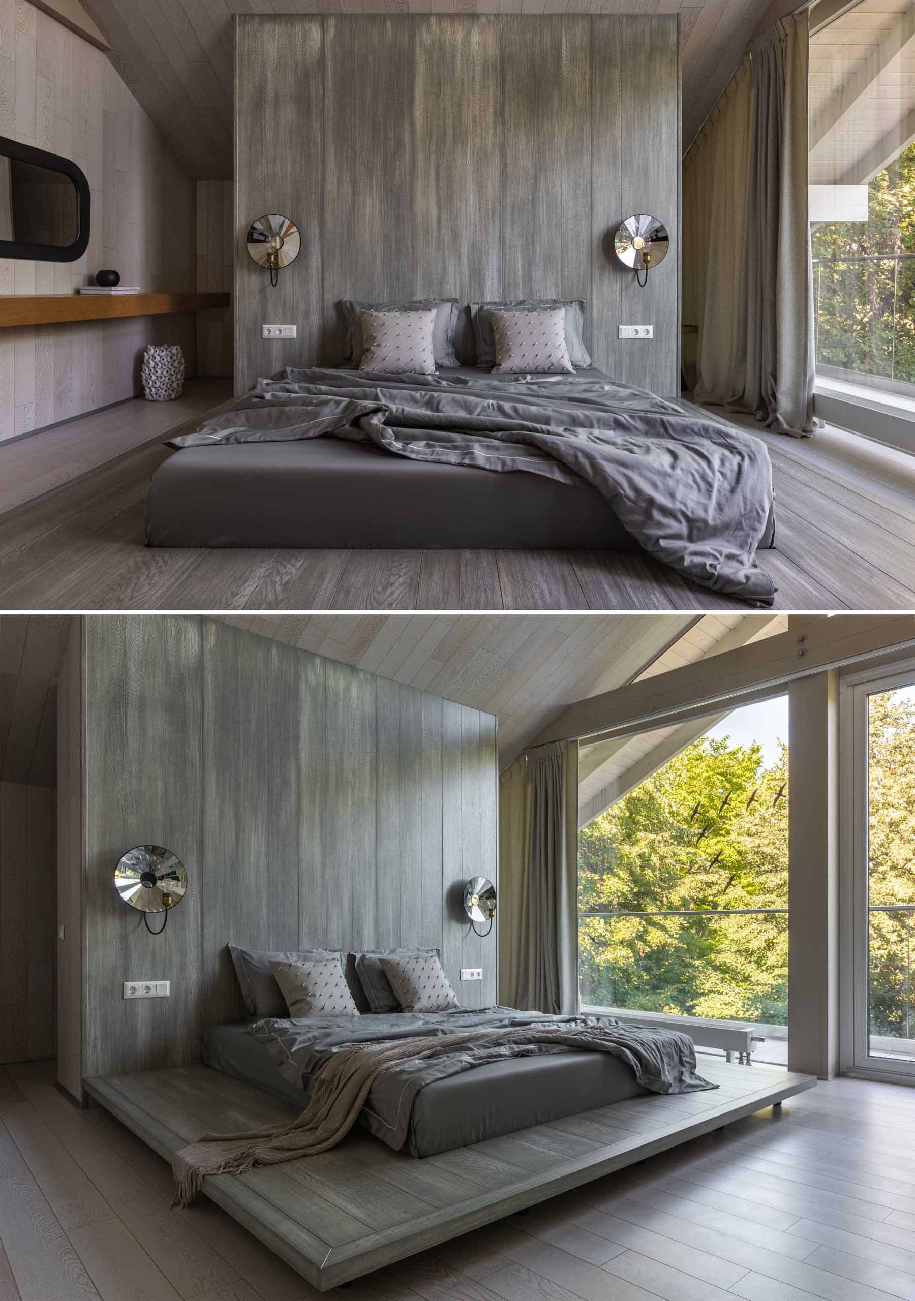 In this contemporary bedroom.,the grey color palette contrasts the lighter areas of the ،me, while floor-to-ceiling windows fill the room with ample natural light.