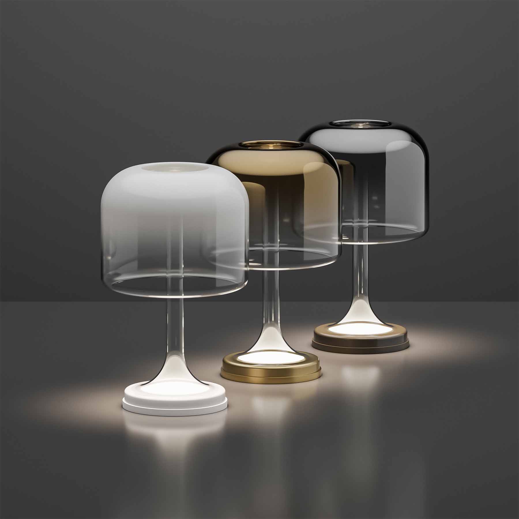 The stylized silhouette of the classic table lamp resembles a magic ball or cast. The lamp resembles a levitating object, its upper ceiling is filled with light, although wires or metal reinforcement do not lead to it. It also feels airy thanks to a transparent silhouette of blown glass.