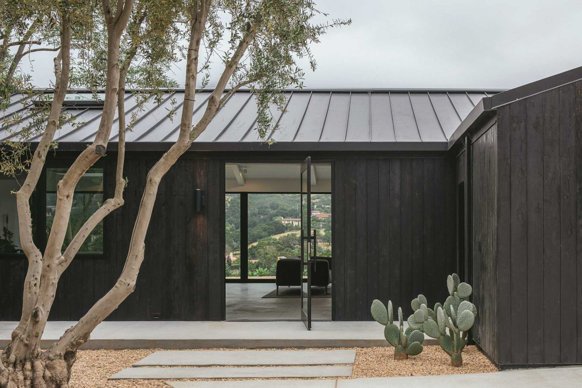 Existing board-and-batten wood siding on this renovated home was replaced with new charred shou sugi ban cedar cladding.